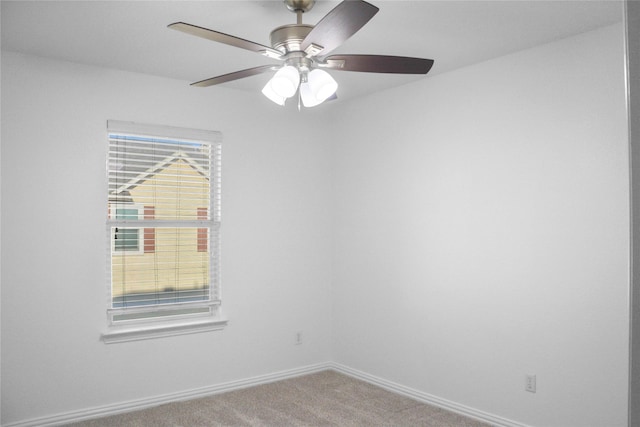 spare room with carpet and ceiling fan