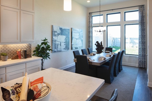 dining area with dark hardwood / wood-style flooring