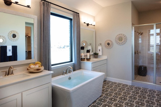 bathroom featuring shower with separate bathtub, a healthy amount of sunlight, and vanity