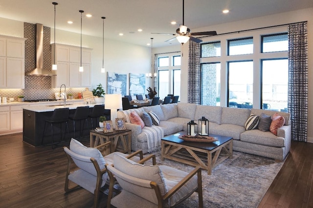 living room with ceiling fan, dark wood-type flooring, and sink