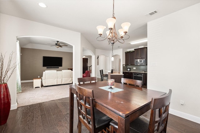 dining space featuring dark hardwood / wood-style flooring and ceiling fan with notable chandelier