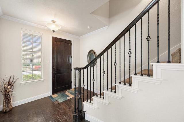 entrance foyer with dark hardwood / wood-style flooring and ornamental molding