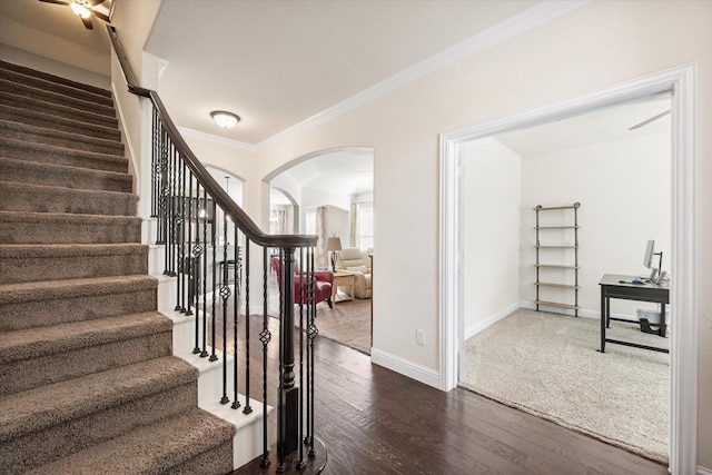 staircase featuring hardwood / wood-style flooring and crown molding