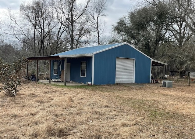 view of outdoor structure featuring central AC unit and a garage