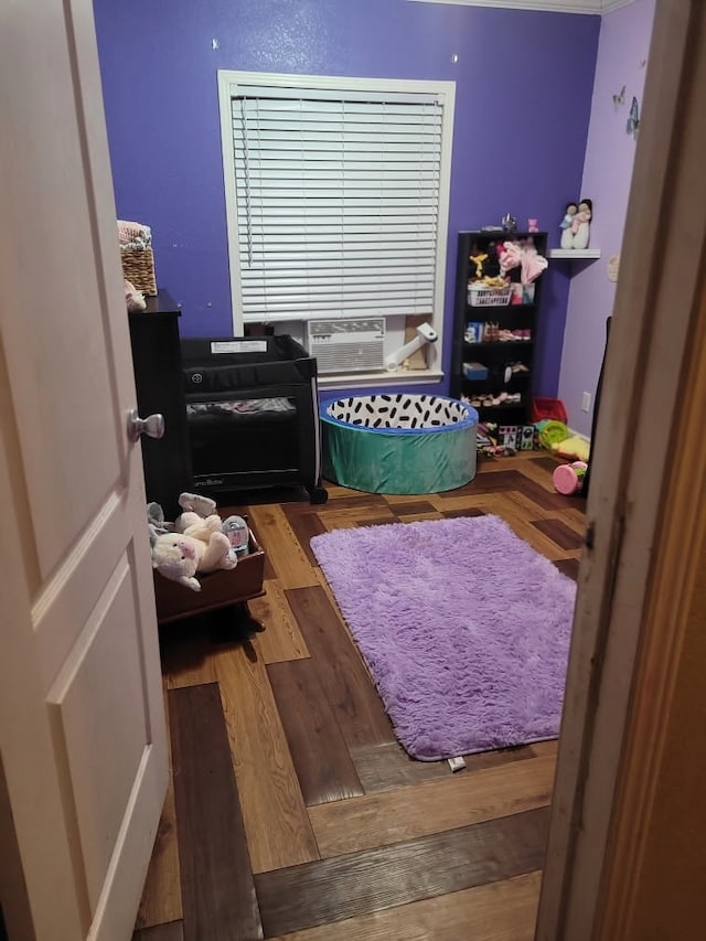 bedroom featuring hardwood / wood-style flooring and cooling unit