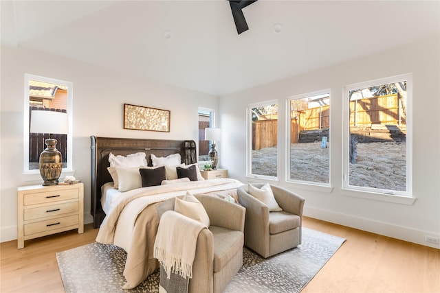 bedroom featuring light wood-style floors and baseboards