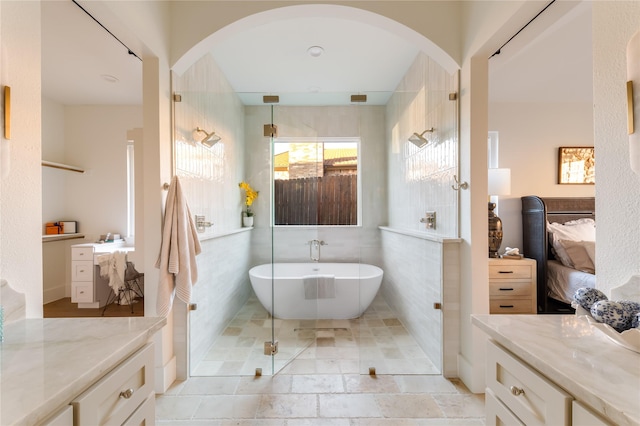 full bath with a soaking tub, a shower stall, and vanity