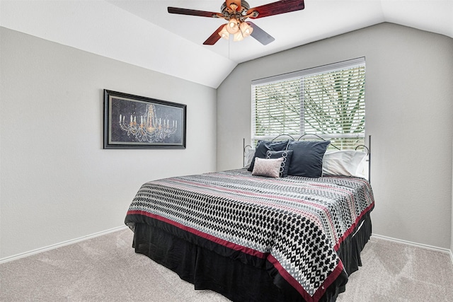 bedroom with ceiling fan, light colored carpet, and vaulted ceiling