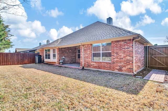 rear view of house featuring a patio area, cooling unit, and a yard