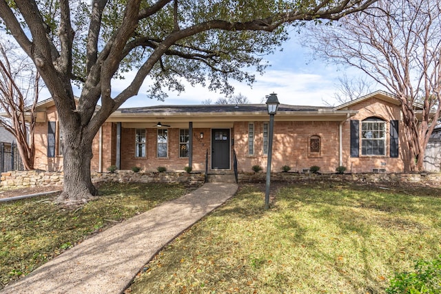 single story home featuring brick siding and a front yard