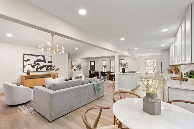 living area with recessed lighting and light wood finished floors