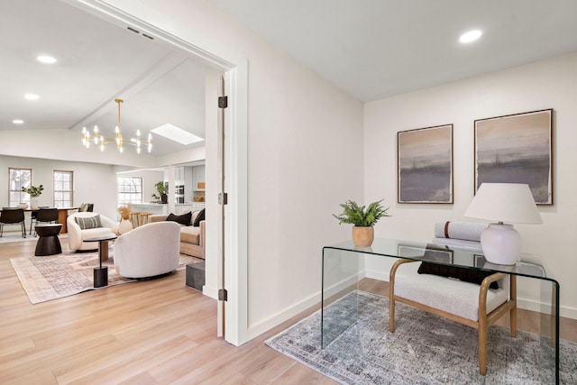 office area with light wood-type flooring, vaulted ceiling with skylight, baseboards, and recessed lighting