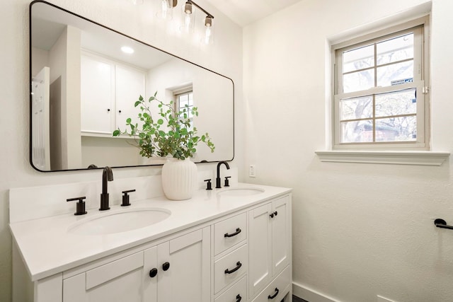 bathroom with double vanity and a sink