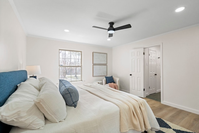 bedroom with baseboards, ceiling fan, wood finished floors, crown molding, and recessed lighting