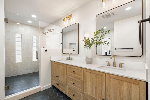 bathroom with double vanity, a sink, visible vents, and a shower stall