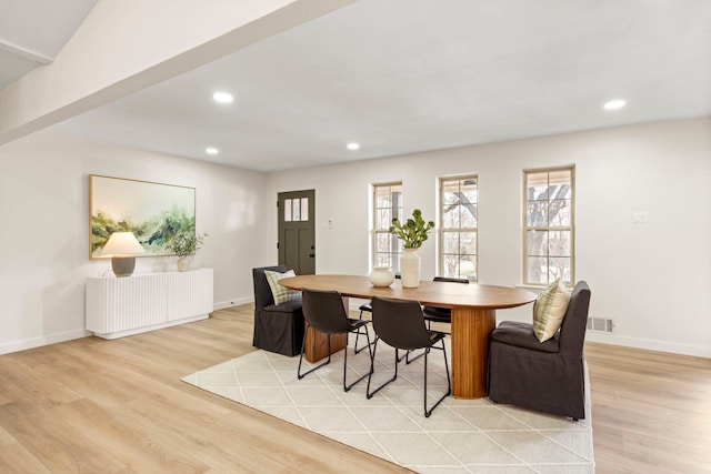 dining space featuring recessed lighting, radiator, baseboards, and light wood finished floors