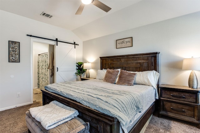 carpeted bedroom featuring ceiling fan, a barn door, vaulted ceiling, and connected bathroom