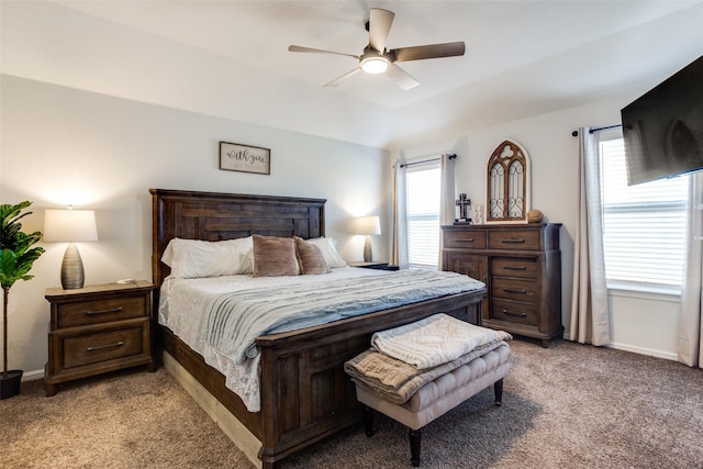 bedroom featuring ceiling fan, multiple windows, and light carpet