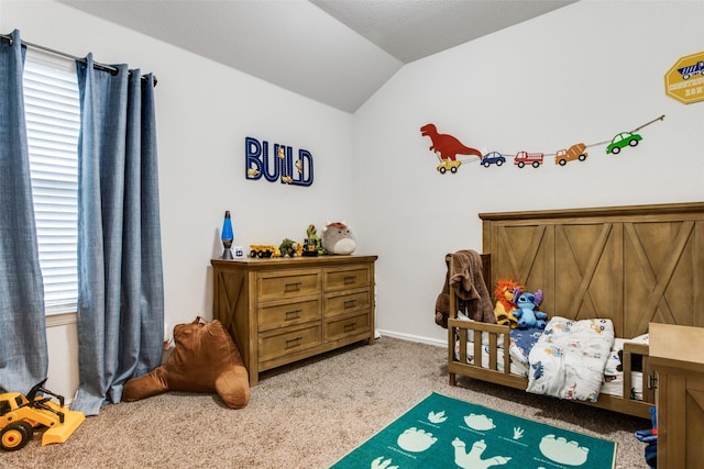 carpeted bedroom with lofted ceiling