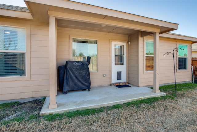 view of exterior entry featuring a patio