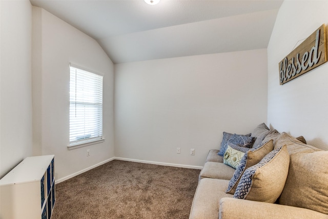 living room with lofted ceiling and dark colored carpet