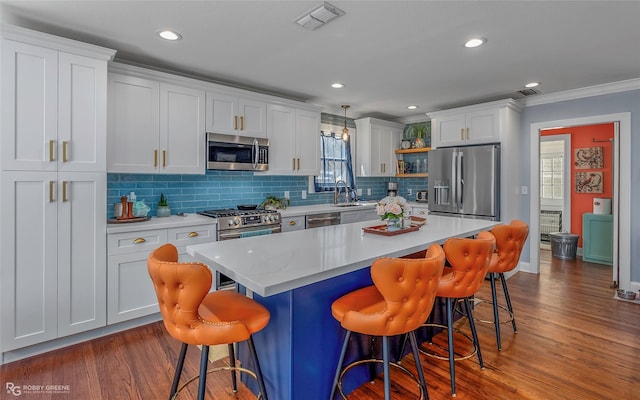 kitchen with visible vents, appliances with stainless steel finishes, light countertops, and open shelves