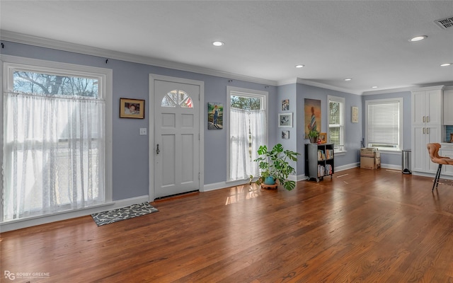 foyer featuring recessed lighting, crown molding, baseboards, and wood finished floors