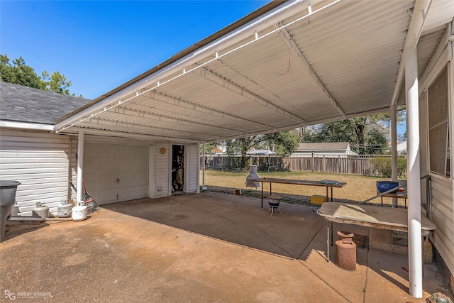 view of patio / terrace featuring driveway and fence