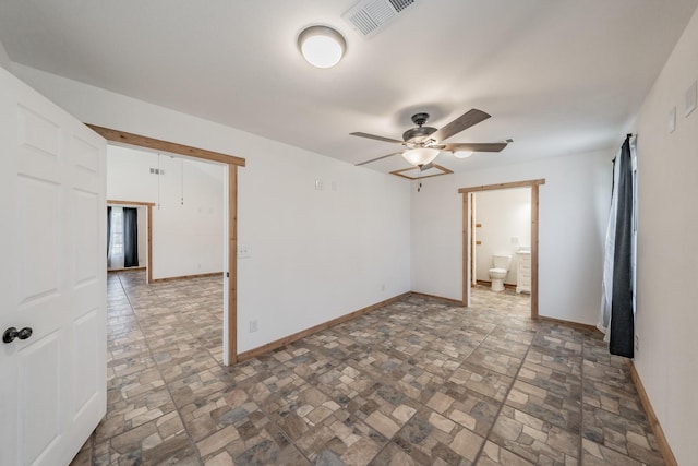 empty room with baseboards, visible vents, and a ceiling fan