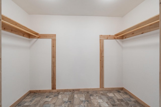 spacious closet with stone finish floor