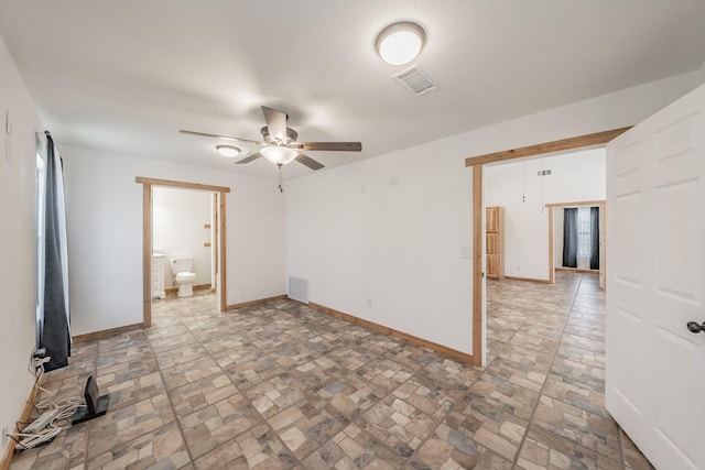 empty room with a ceiling fan, visible vents, and baseboards