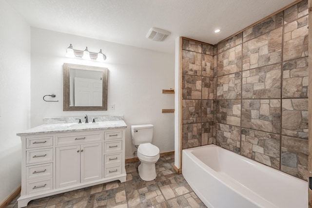 full bathroom with baseboards, visible vents, toilet, stone finish floor, and vanity