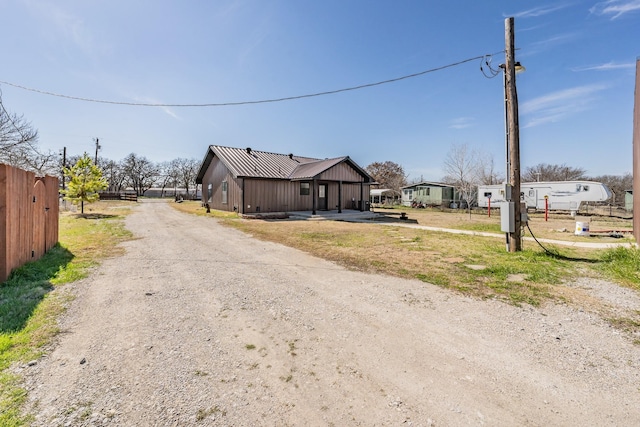 view of street with dirt driveway