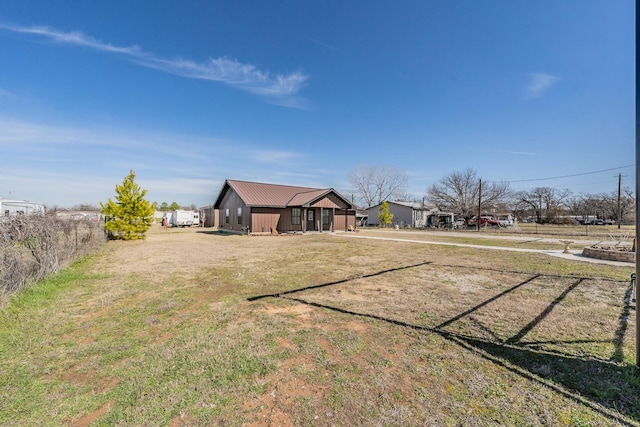 view of front of property with metal roof and a front yard