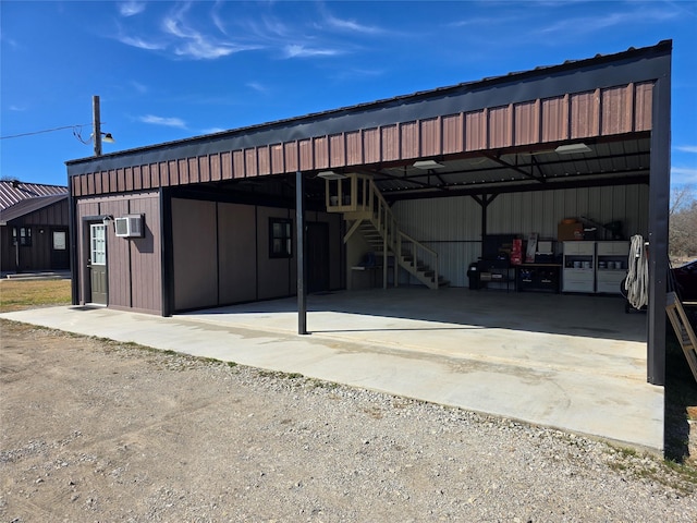 exterior space featuring dirt driveway and a carport