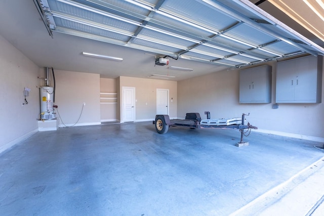 garage with a garage door opener and water heater