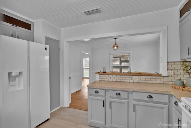 kitchen with visible vents, white appliances, light countertops, and crown molding