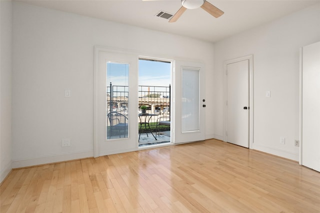 empty room with ceiling fan and light hardwood / wood-style floors