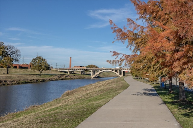 view of home's community featuring a lawn and a water view