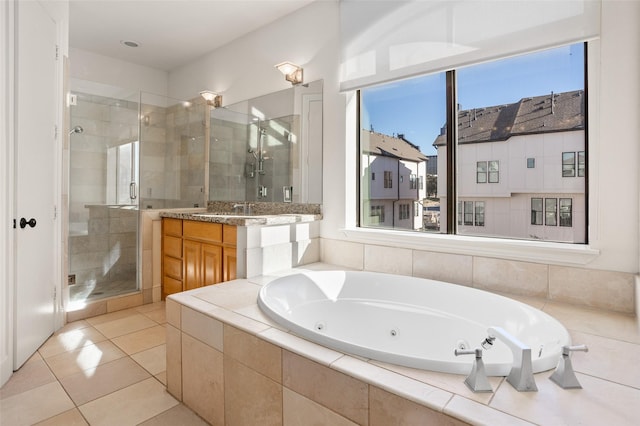 bathroom with separate shower and tub, tile patterned flooring, and vanity