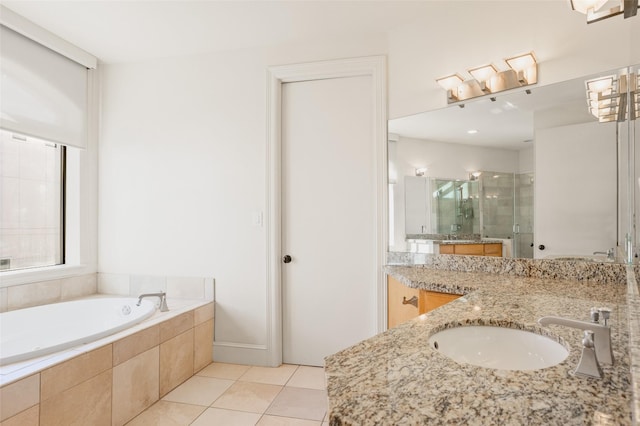 bathroom with plus walk in shower, vanity, and tile patterned floors