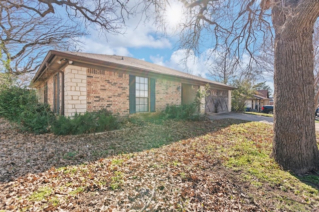 view of front of property featuring a garage and brick siding