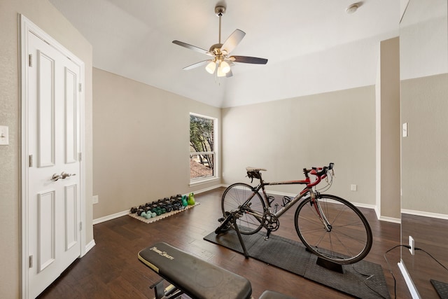 exercise room featuring lofted ceiling, ceiling fan, baseboards, and wood finished floors