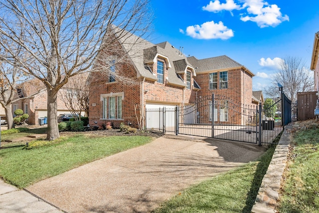 view of front of home with brick siding, concrete driveway, a gate, fence, and a garage