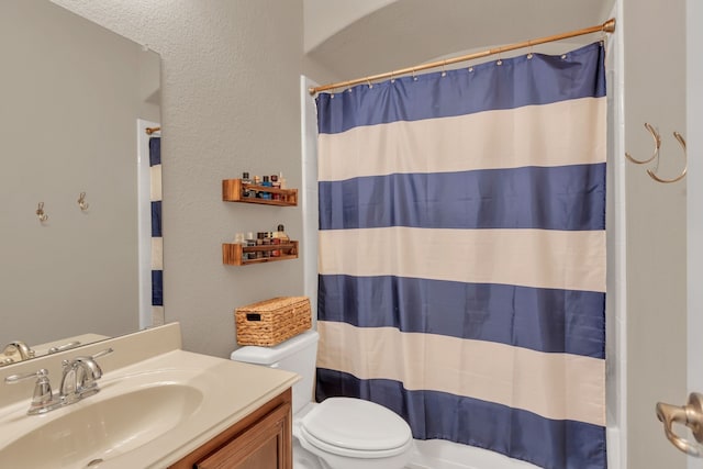 bathroom with toilet and vanity