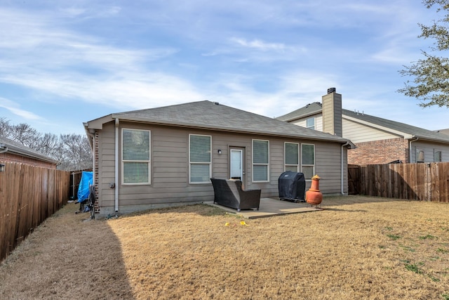 rear view of property with a lawn and a patio