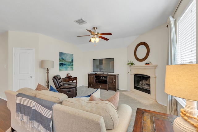 living room with ceiling fan and lofted ceiling