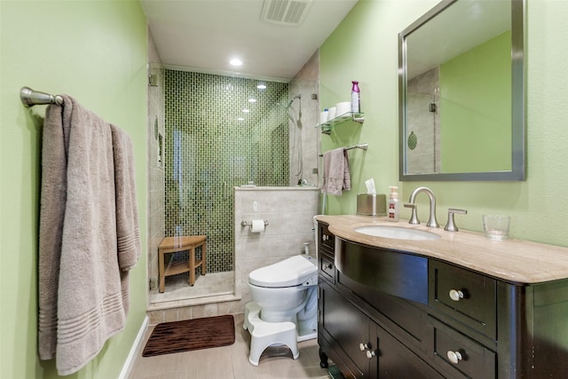 full bathroom with toilet, vanity, visible vents, and a tile shower