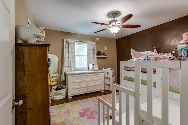 bedroom with ceiling fan and dark wood finished floors