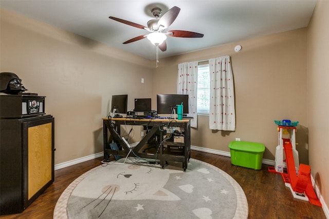 office with dark wood finished floors, a ceiling fan, and baseboards